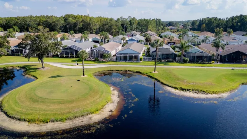 Aerial View Showcasing Golf Course & Water Behind the Home