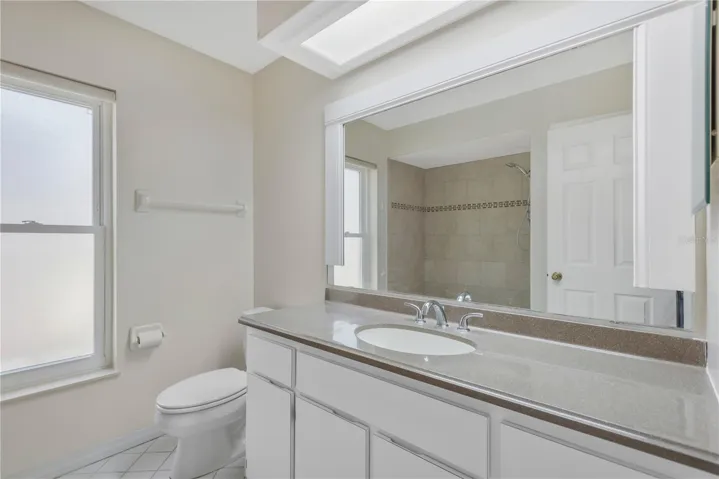 Guest bath vanity with abundance of storage cabinets.