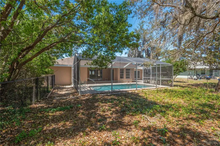 Backyard to pool and cage.