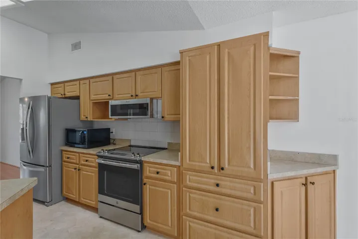Kitchen offers abundance of upper and lower cabinets for storage.