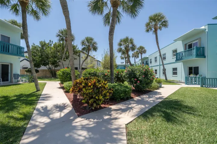 Palm-lined community courtyard with paved walkway — Ocean Park South, Cape Canaveral
