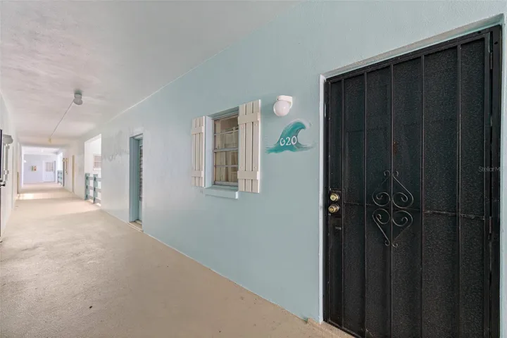 Covered exterior corridor leading to Unit G20 — Ocean Park South, Cape Canaveral