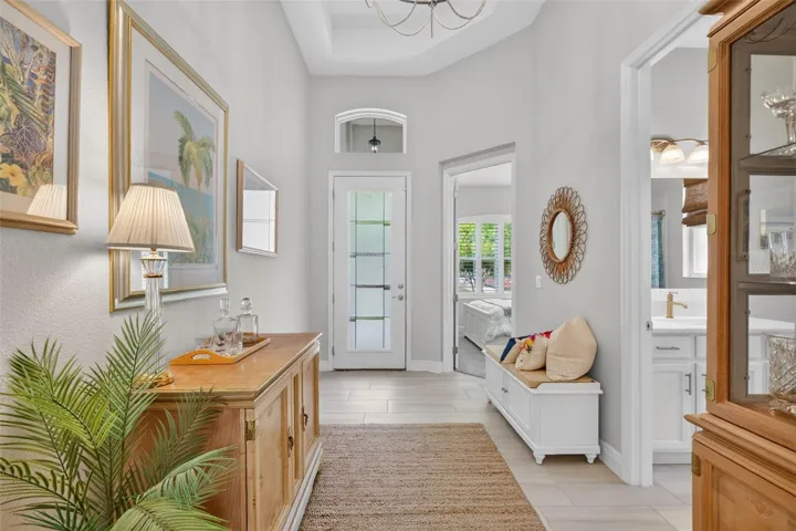 This foyer is the hub and spoke of the home, guest room, office, laundry and garage branch off from here.