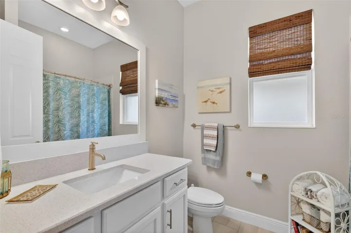 The 2nd bath has an undermount vanity, beautiful countertops and is paired with a shower and tub combo.