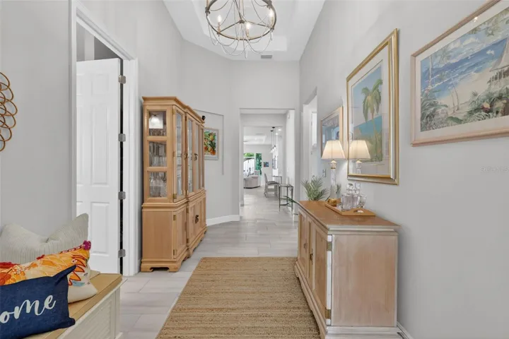 You'll be drawn into the home's central living space down this foyer's hall.
