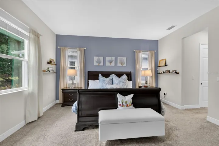 The open, airy, bright and spacious primary bedroom has a elegant en-suite bath and dual walk-in closets.