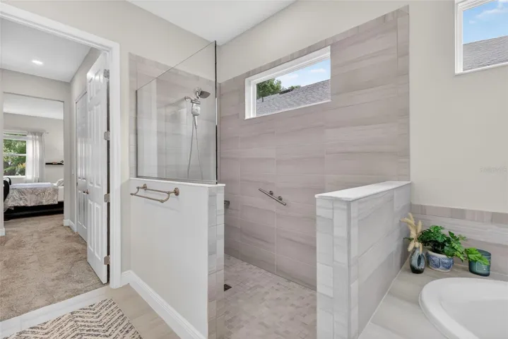 The walk-in shower is both beautiful and functional providing safety with its lipless entry.
