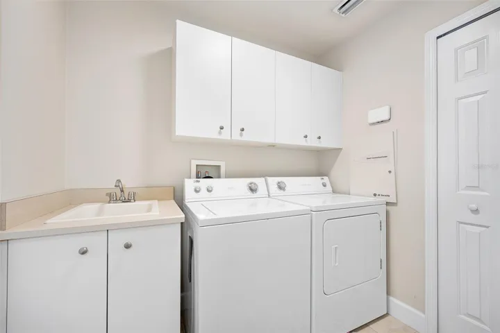 Laundry room w/ utility sink and storage closet