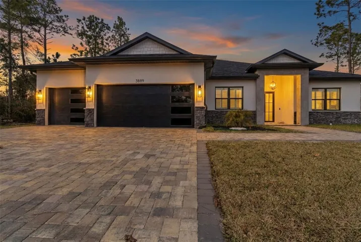 Front exterior at dusk with lighting