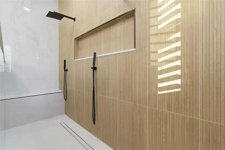 Walk-in shower with tile surround and glass enclosure