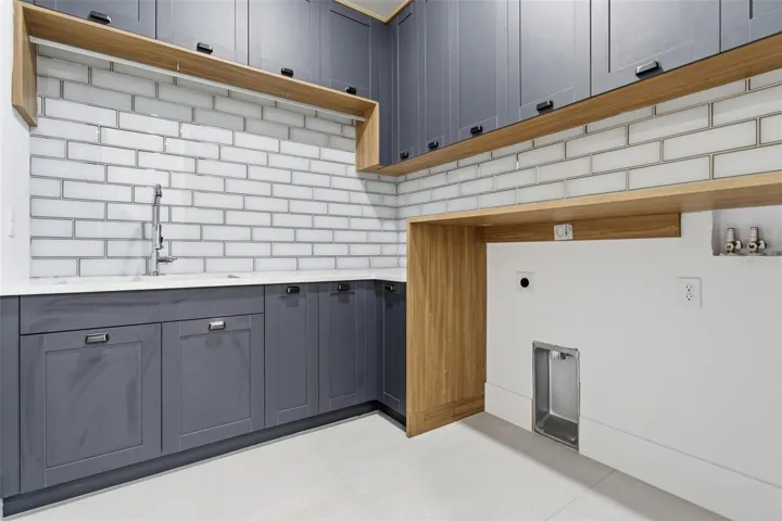 Laundry room with utility sink and built-in cabinetry