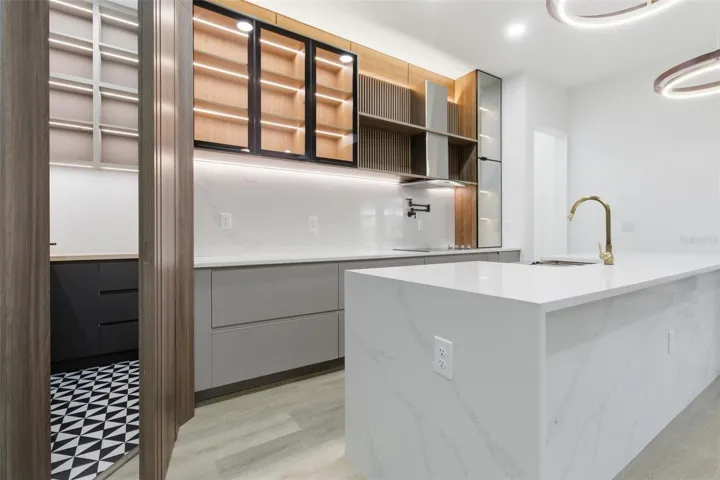 Kitchen with waterfall island and custom cabinetry