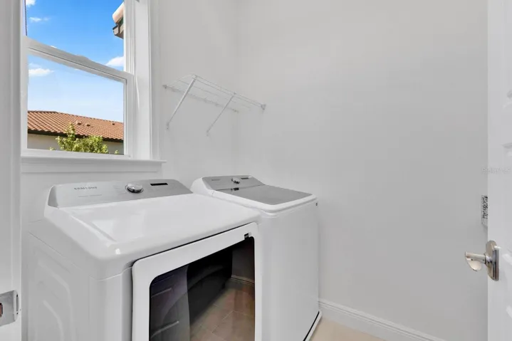Large Laundry Room with counter space on opposite wall conveniently located next to kitchen