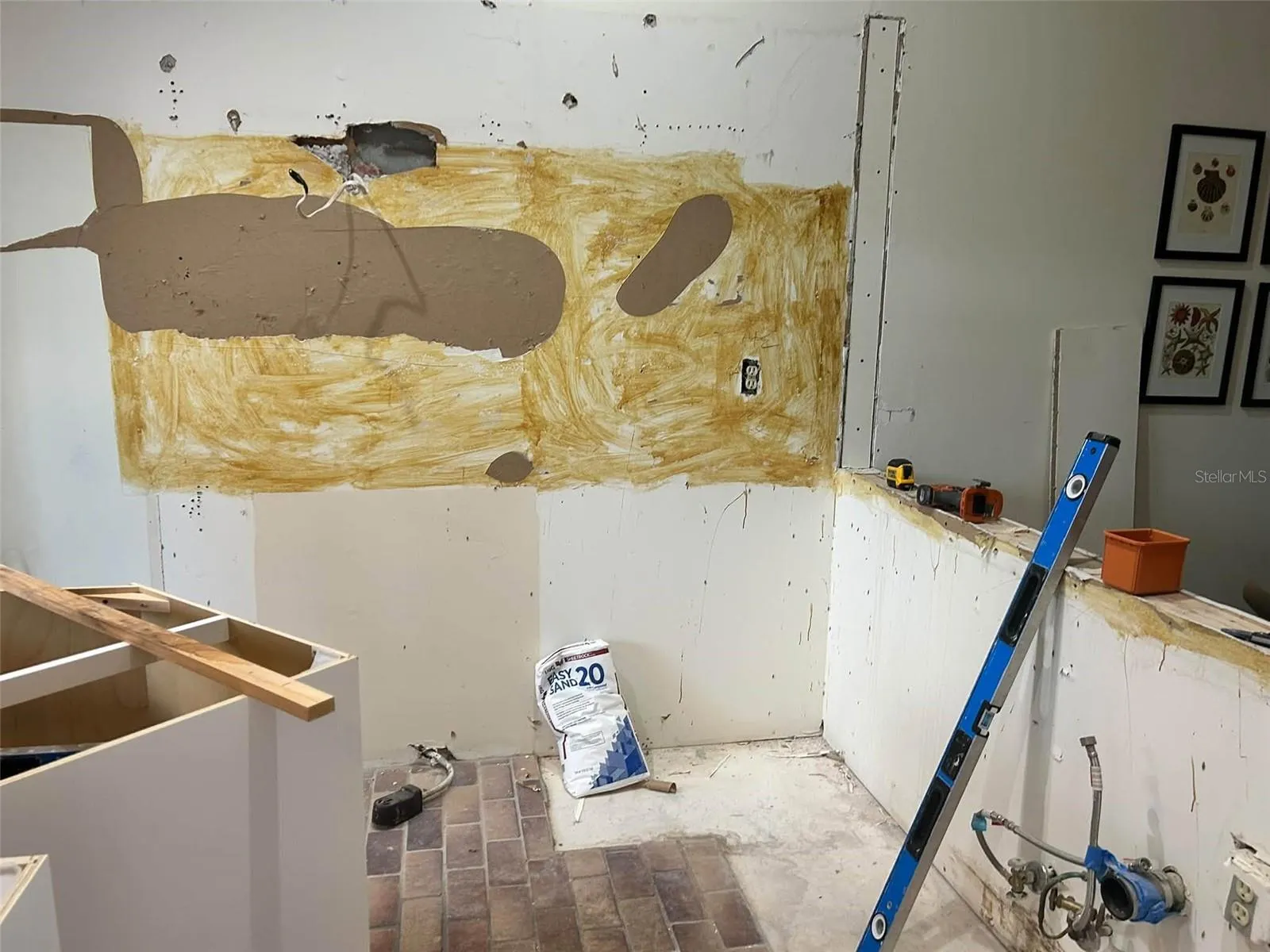 kitchen renovation in progress, white cabinets stainless steel appliances