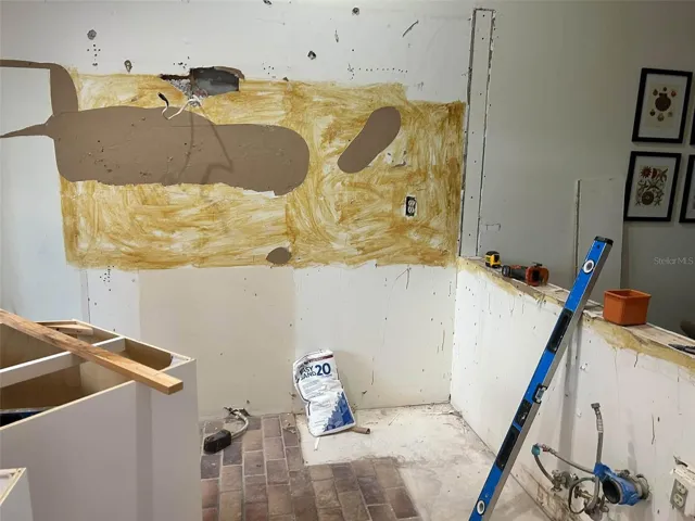 kitchen renovation in progress, white cabinets stainless steel appliances