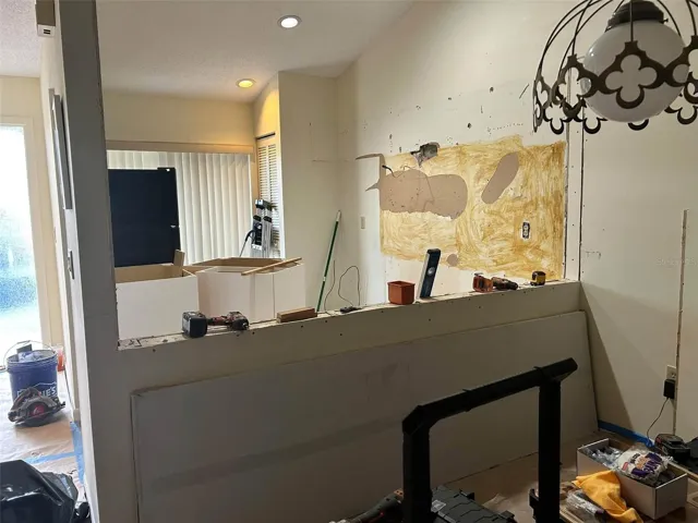 Kitchen renovation in progress, white cabinets, staineless steel appliances