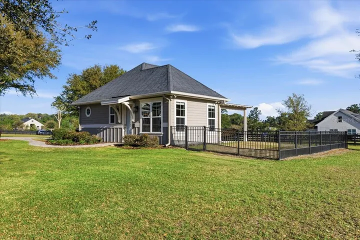 Detached guest house features two bedrooms, full kitchen, one bathroom, living area & stackable washer/dryer.