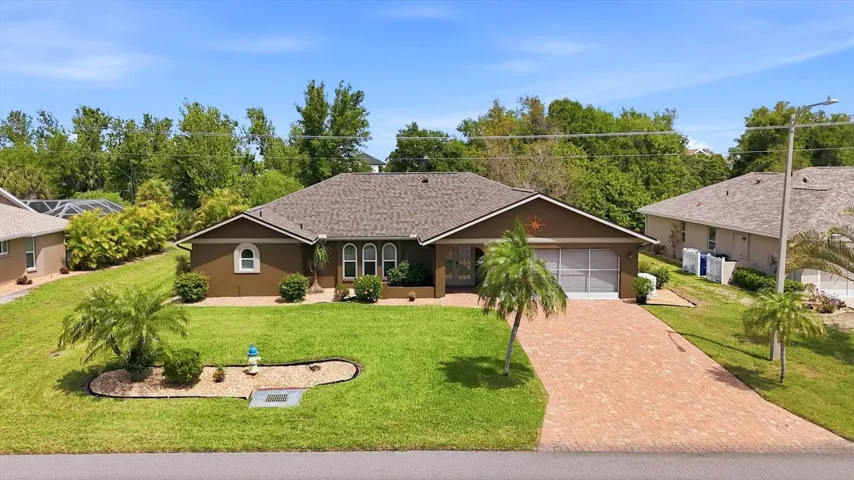 Front aerial showcasing curb appeal and paver driveway