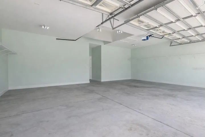 Spacious 3 car garage with items virtually removed.