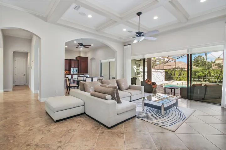 Living room and dining room in background with slider access to covered deck and pool.