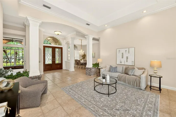 Light and bright formal living room with access to the pool area.