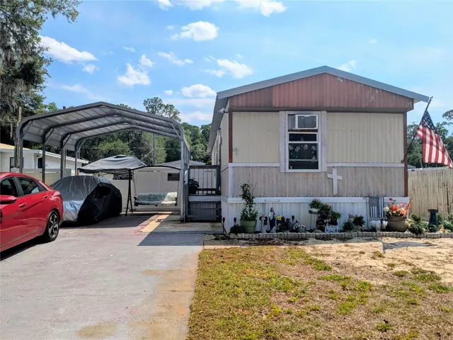 Enjoy the convenience of an oversized carport, offering plenty of room for parking while also creating a versatile space for gatherings or shaded outdoor living.