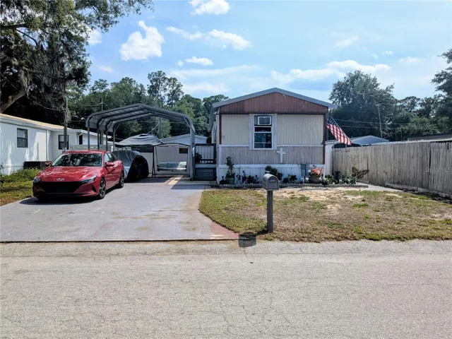 Charming front exterior with covered carport.