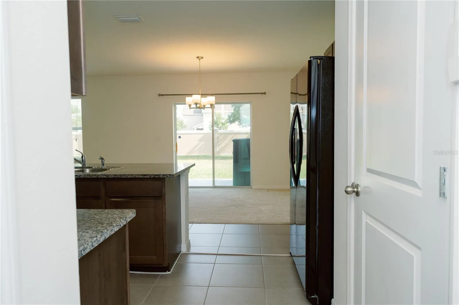 View from garage entry door looking at dinning area and sliding glass door