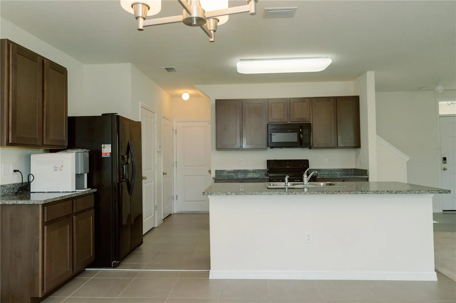 View from the dinning area looking back to pantry, closet and garage doors