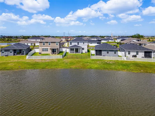 The harmonious streetscape of Sawgrass Lakes features consistent architecture, lush landscaping, and serene water views throughout — this is a community built with pride.