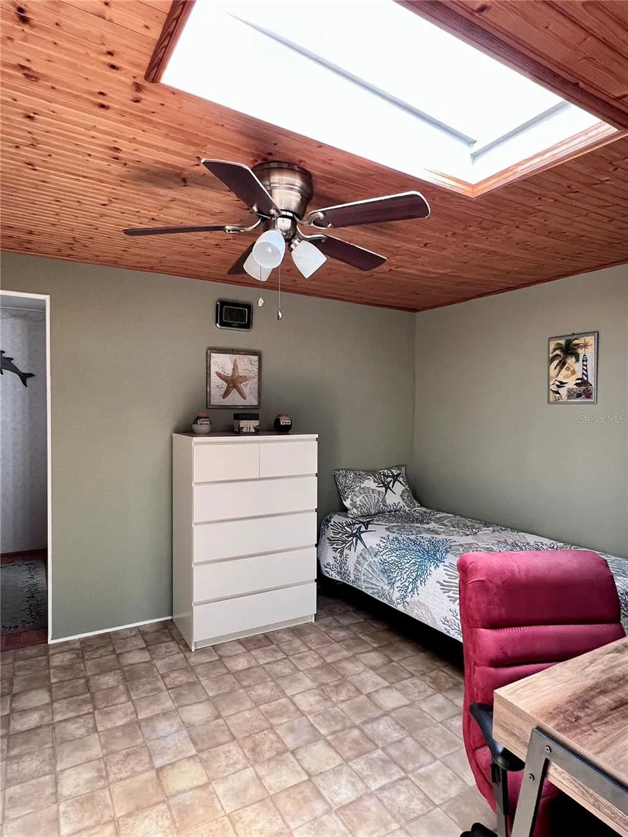 2nd bedroom with skylight and fan