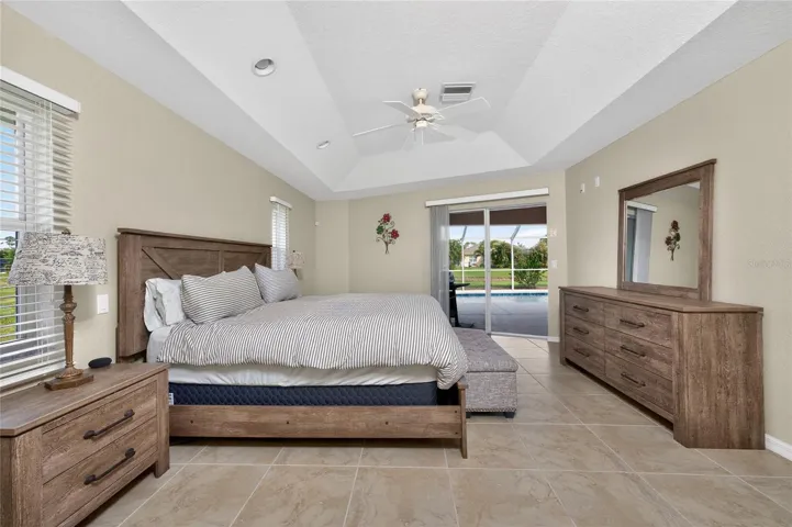 Primary bedroom features sliding glass doors opening onto the lanai.