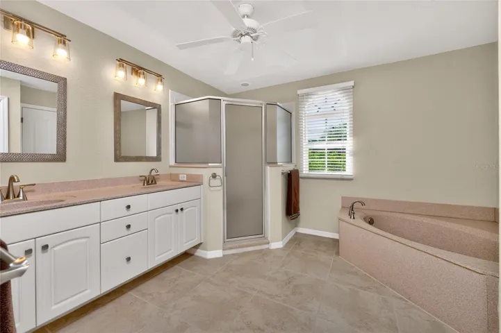 spacious primary bathhas both a garden tub and step in shower.