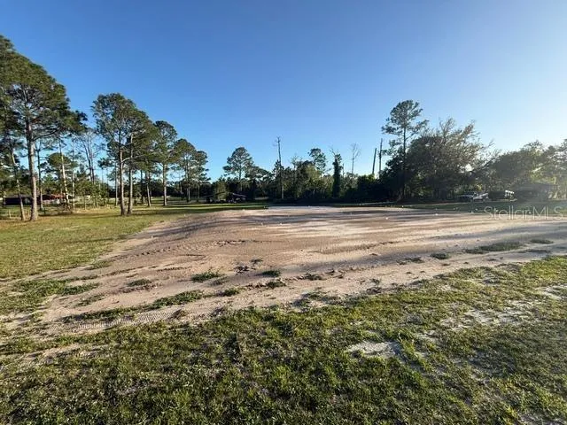 View of property with house pad and pole barn.