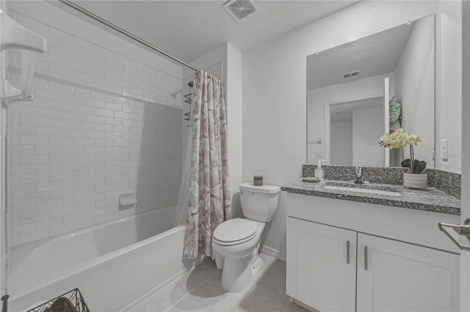 Full Second Bedroom Upstairs with Tile Surround, Square Undermount Sink and Granite Countertops.