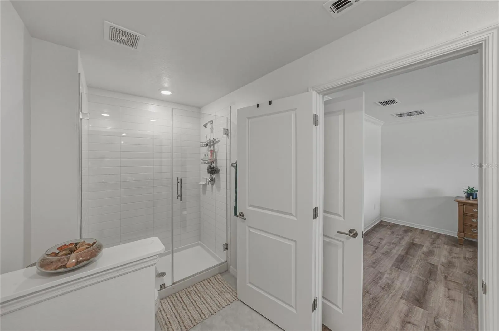 Primary Suite Bath with Privacy Toilet Wall and Tile Shower and Upgraded Frameless Shower Glass