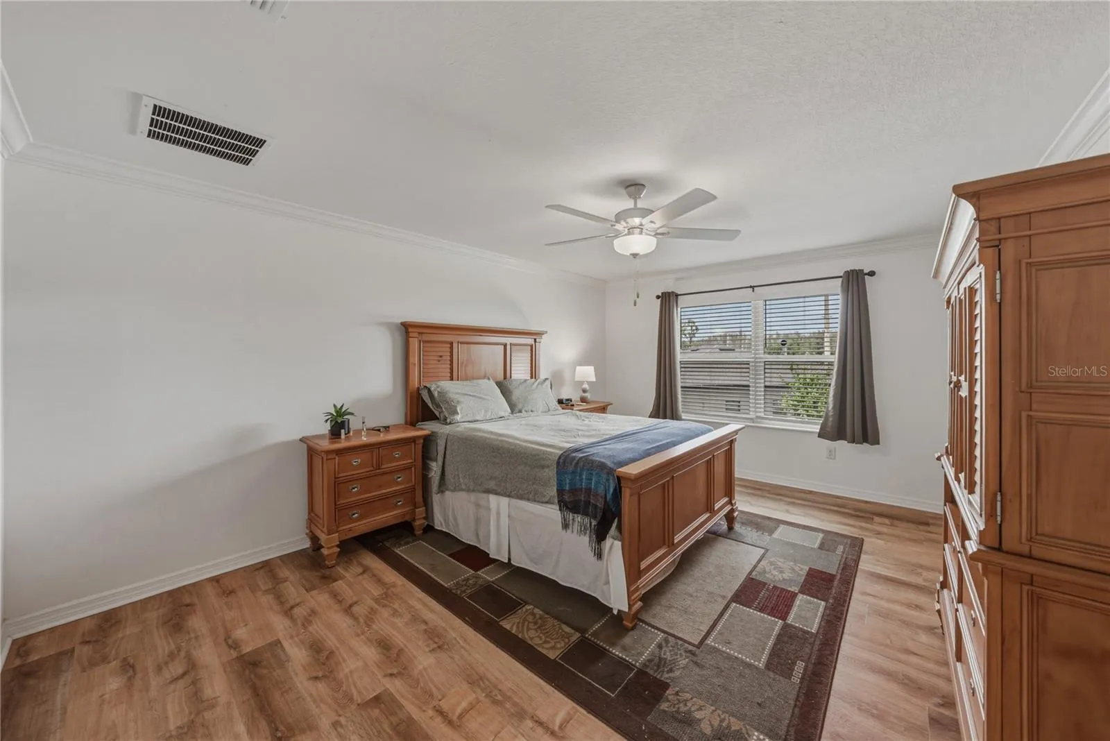 Primary Suite with Crown Molding and Ceiling Fan