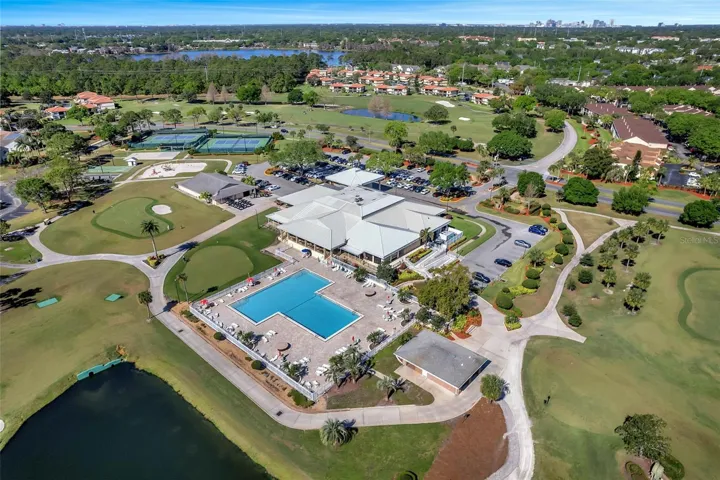 Ventura Clubhouse with restaurant's  balcony looking over Jr. Olympic sized pool and practice putting green.