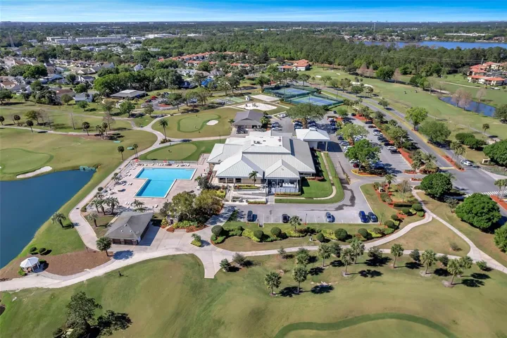 Ventura Clubhouse with restaurant's balcony looking over Jr. Olympic sized pool and practice putting green. Wedding Gazebo on the left and Restroom Building near pool