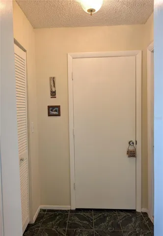 Hallway to Garage - Storage Closet to the left, 2nd Bathroom center and Garage to the right