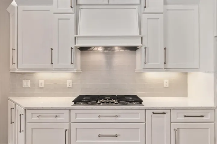 Gas cooktop, upgraded stainless steel appliances, tile black backsplash