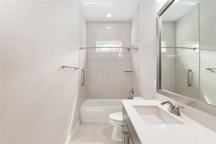 Guest bathroom with tub, shower combo and quartz countertops