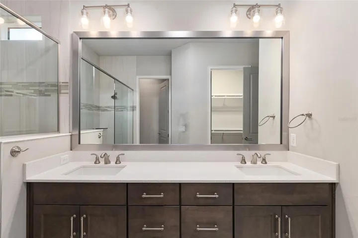 Double vanities with quartz countertops