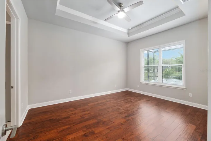 Master bedroom with new upgraded engineered hardwood floor and tray ceiling