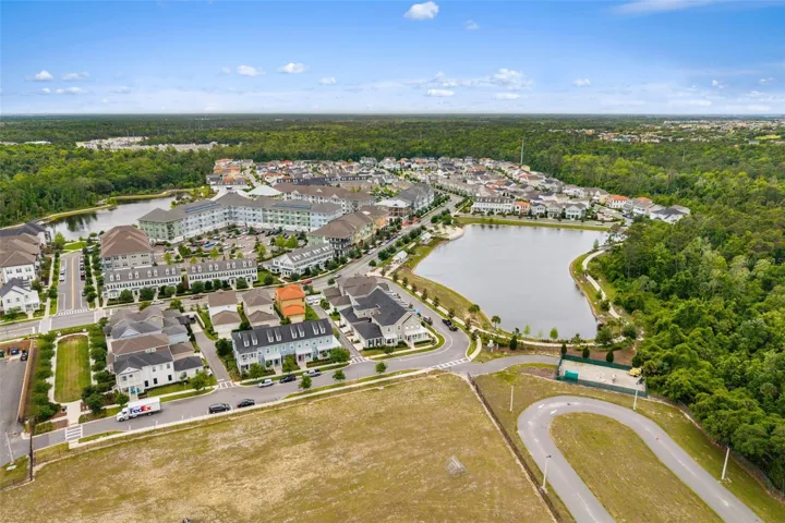 Aerial View of Townhome corner lot across the street from water feature and walking trails