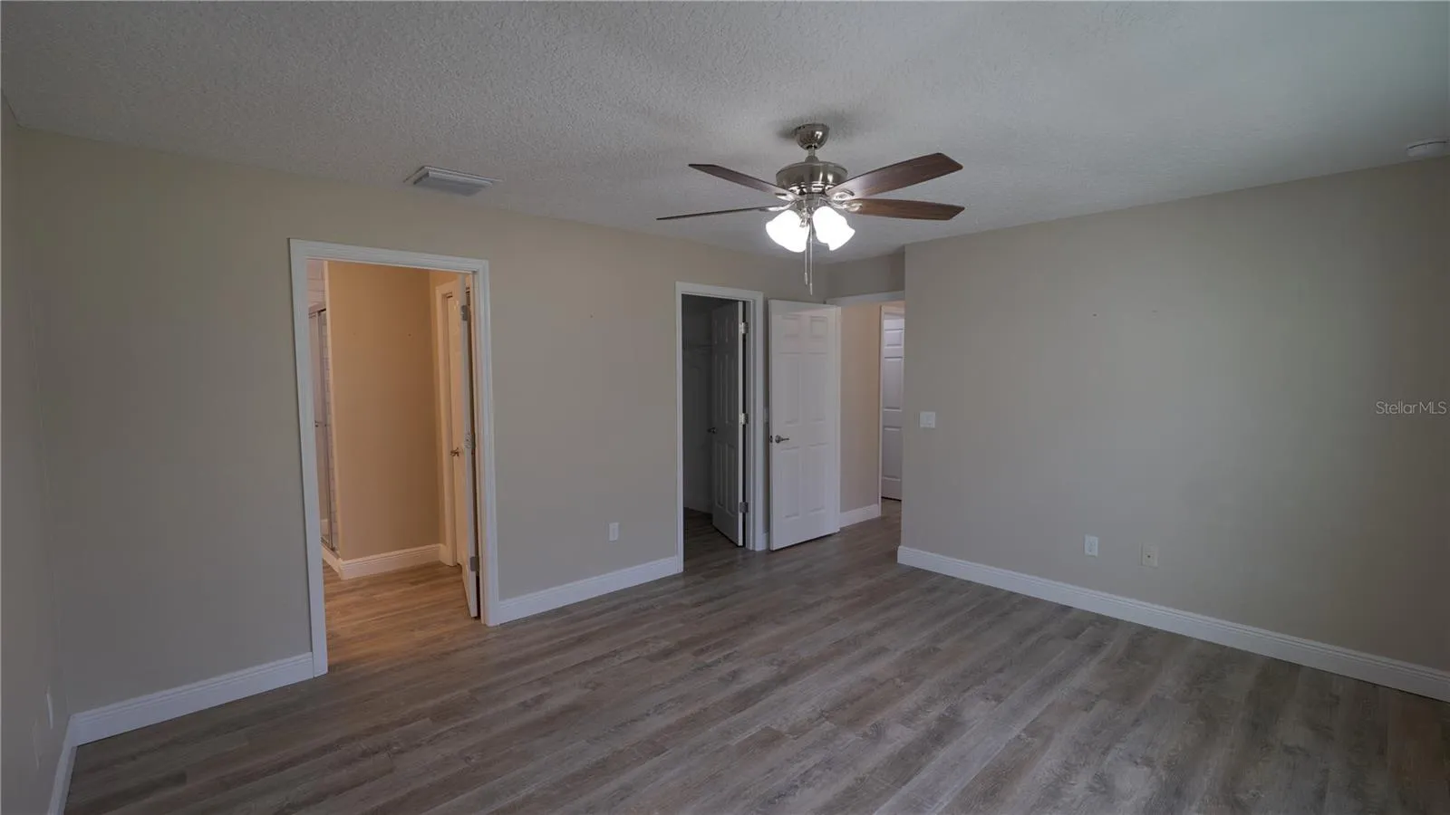 Primary Bedroom with view to Master Bath and Primary Closet