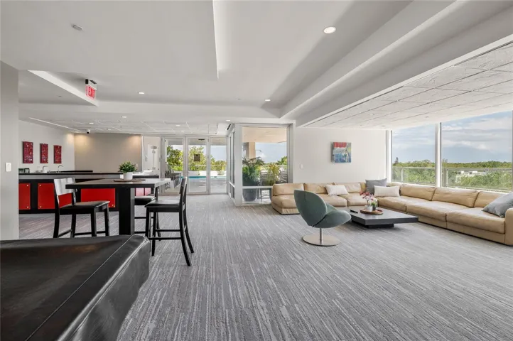 Open concept gathering area with seating and kitchen.