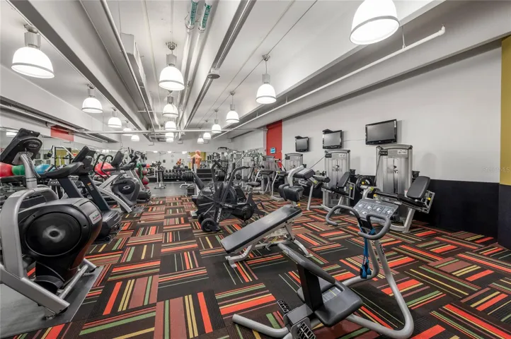 Gym with cardio equipment, free weights, and strength machines
