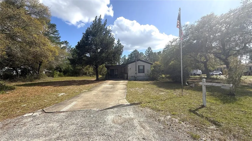 Side of home. Carport/Driveway