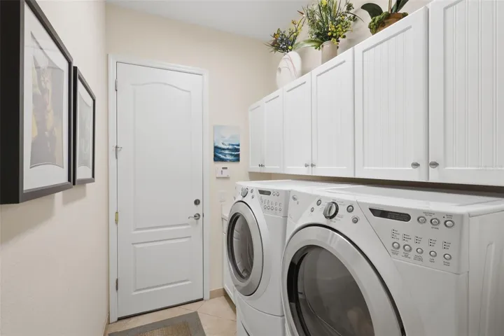 Laundry with cabinets and front load washer and dryer